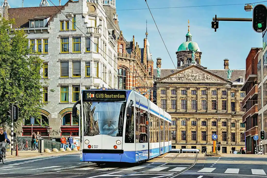 Amsterdam tram crossing a canal bridge, covered by the GVB pass