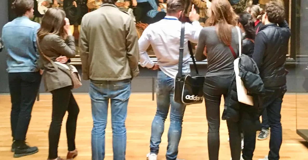 Small tour group in front of paintings in the Rijksmuseum